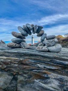 lighthouse on a beach with rocks